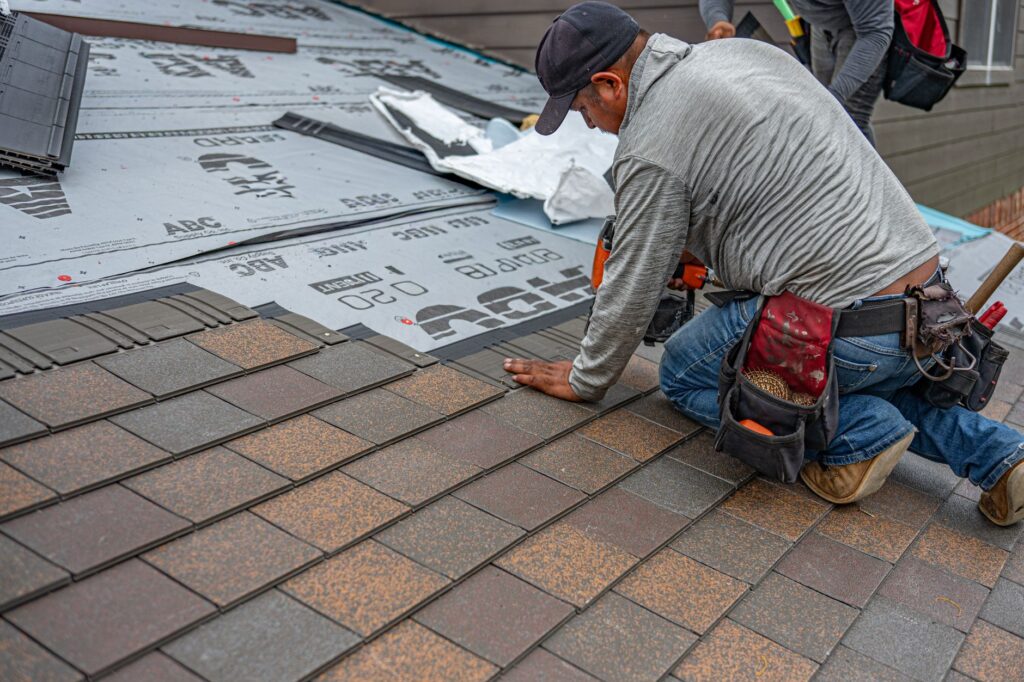 Skilled roofer installing asphalt shingles, a key visual for choosing roofing marketing companies that drive real results