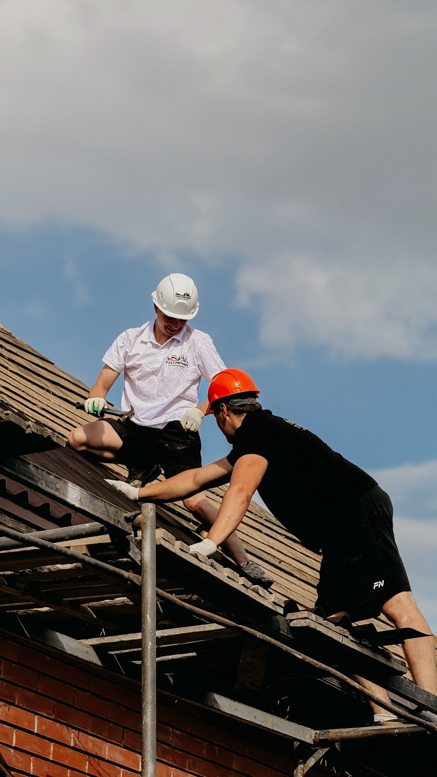Roofing crew repairing a rooftop under clear sky — SEO results for roofing companies